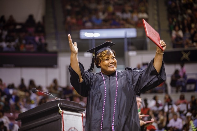 Andrea Ross walking across the stage at Trident Technical College’s 2025 commencement ceremony.